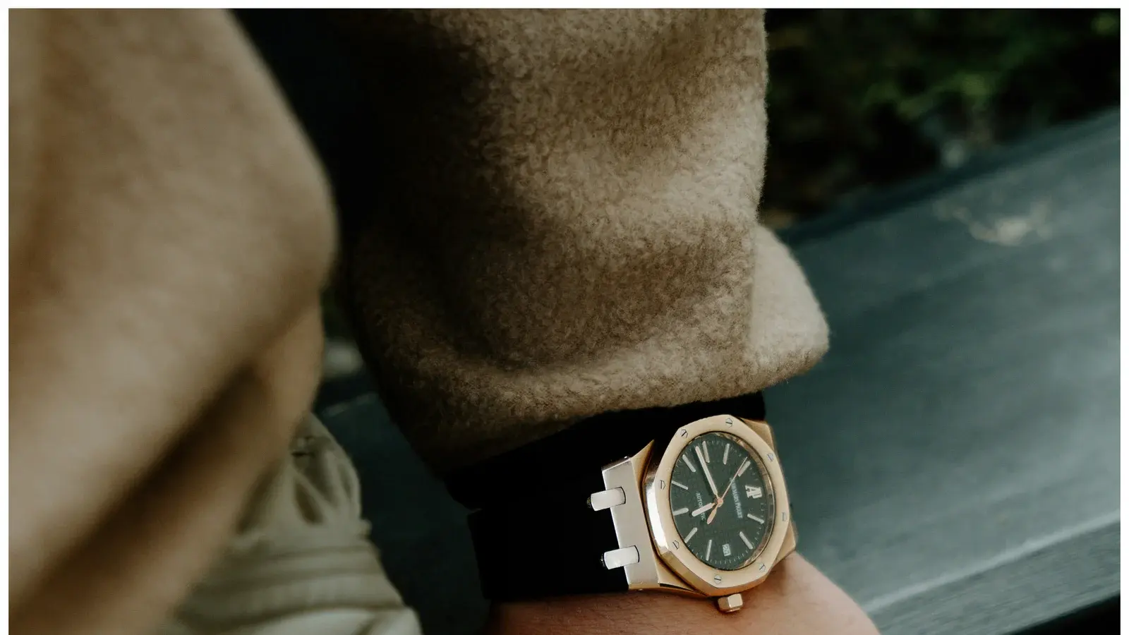 An octagonal-bezel sports watch on an integrated bracelet, worn at the wrist