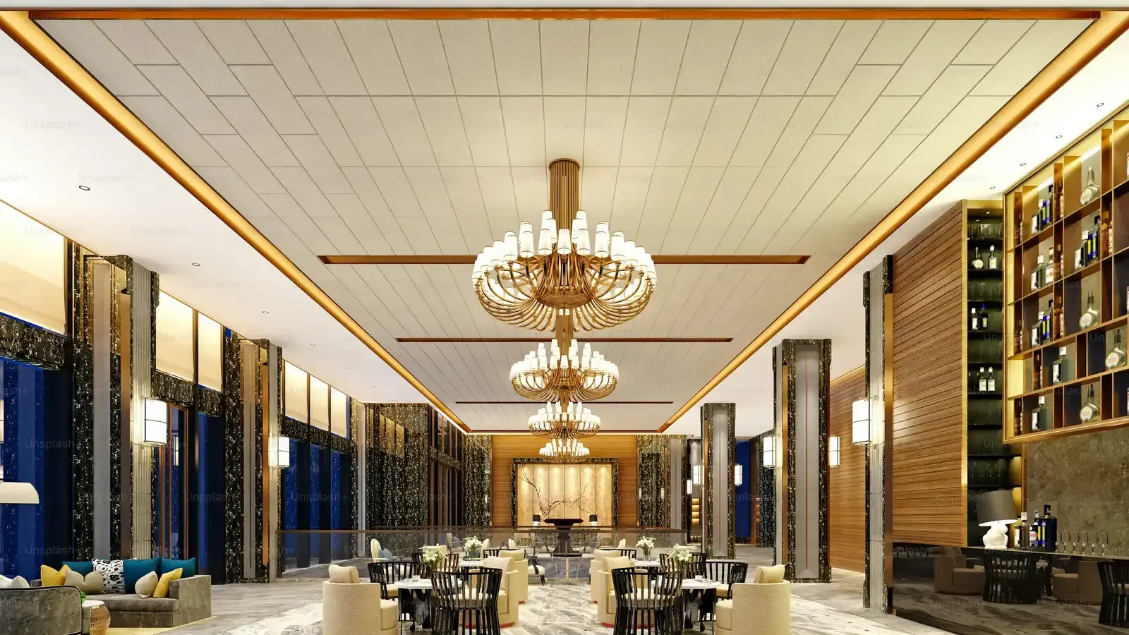 A hotel lobby with tiered crystal chandeliers above a polished floor
