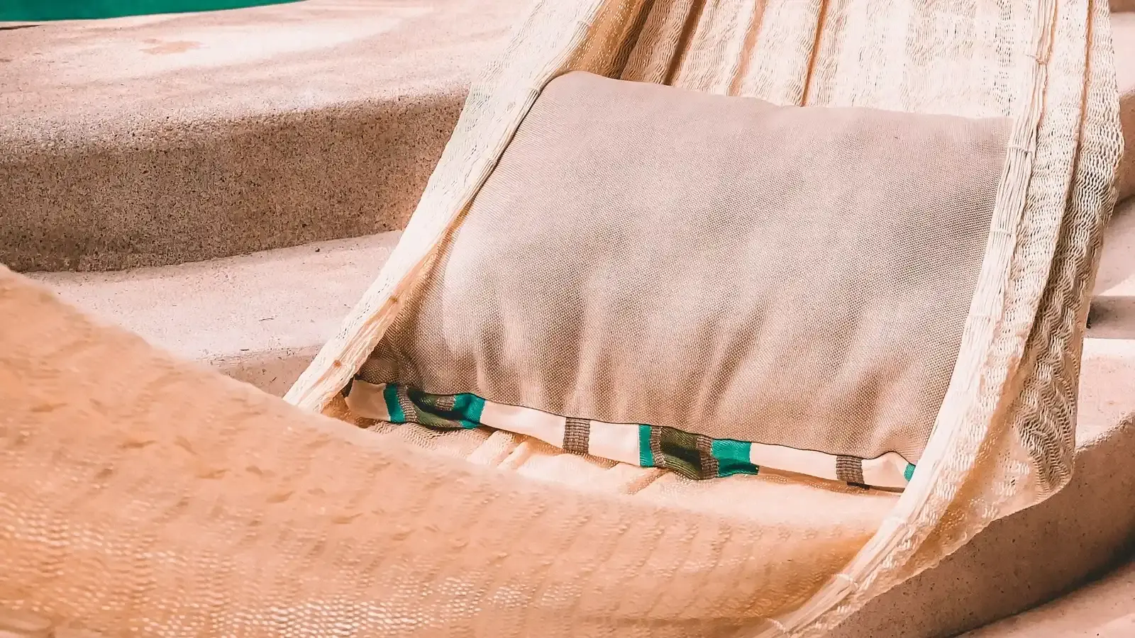 A close view of a striped cushion resting in a hammock