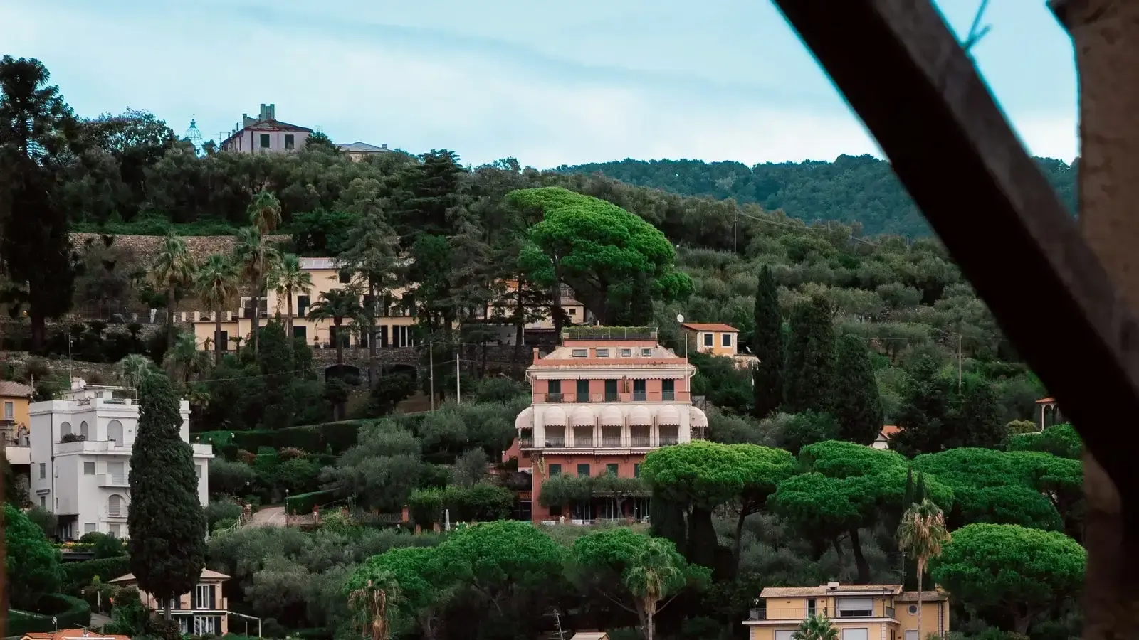 Hillside villas among umbrella pines above a Mediterranean bay