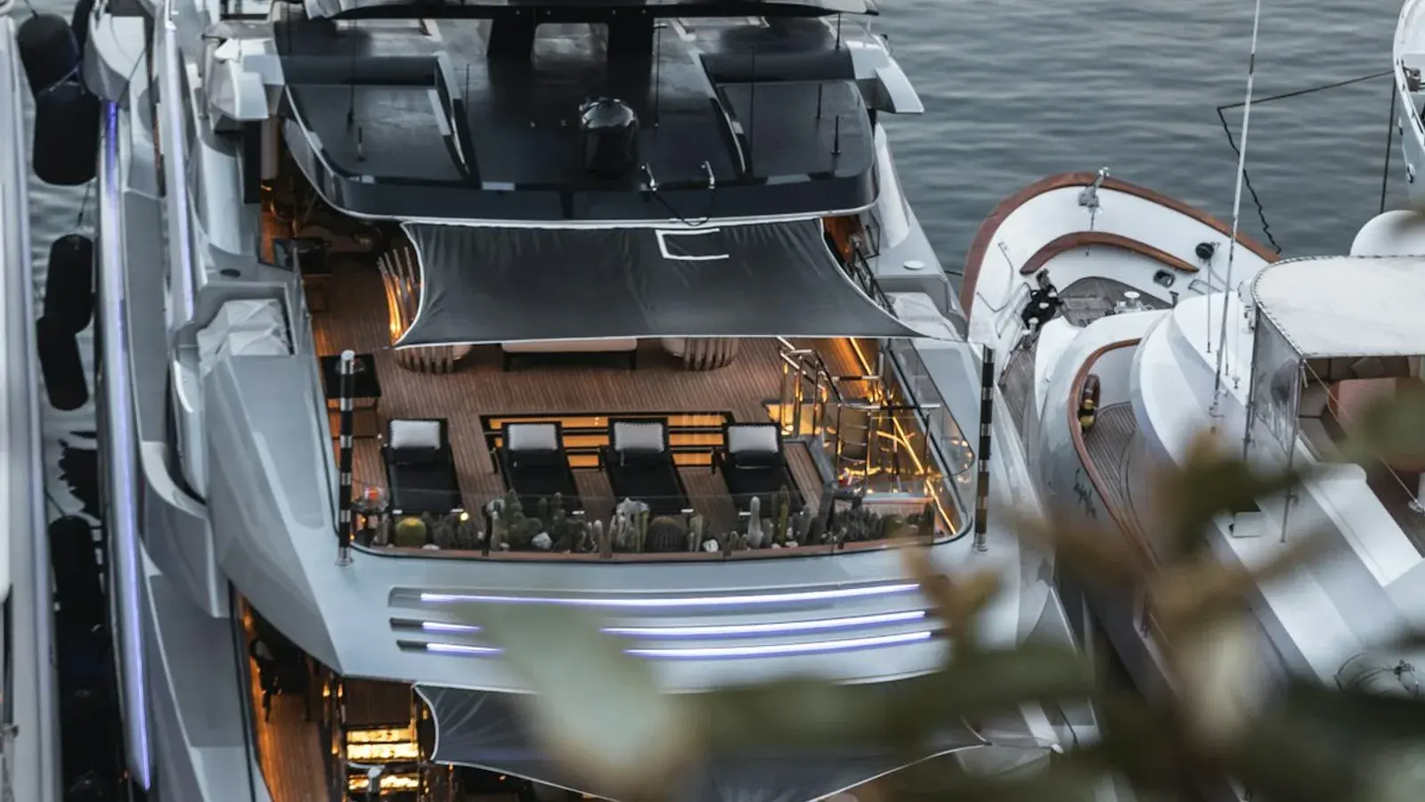 The sun deck and tender of a moored superyacht seen from above